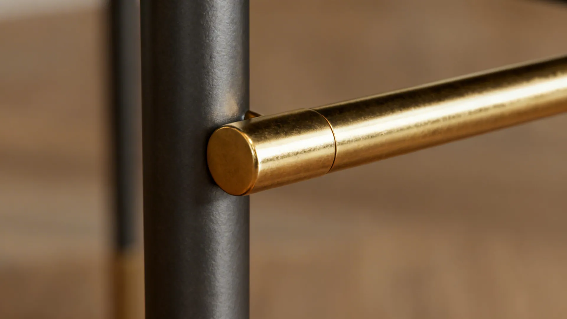 Powder-coated steel leg and solid brass accent close-up showing finish and texture.