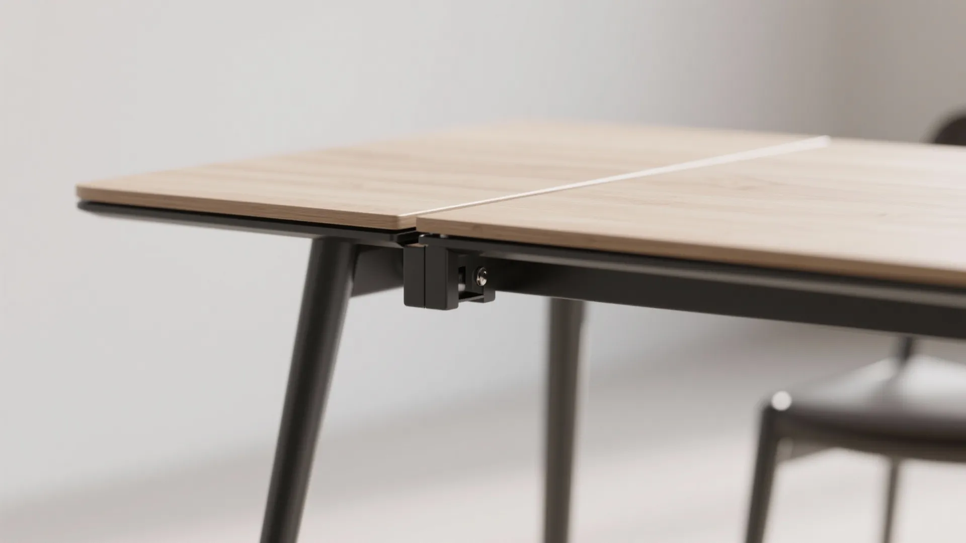 Close-up of a slim rectangular drop-leaf tabletop with slender metal legs and clean joinery, emphasizing an airy feel.