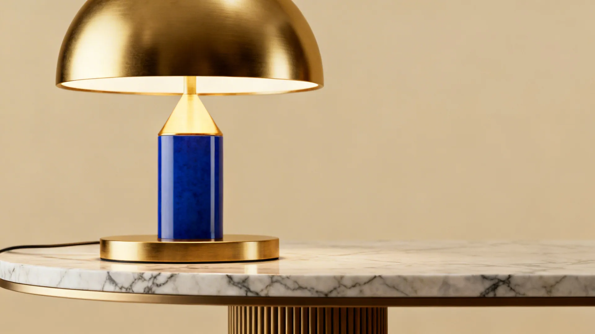 Brushed brass fixture and marble coffee table detail against blue and beige palette.
