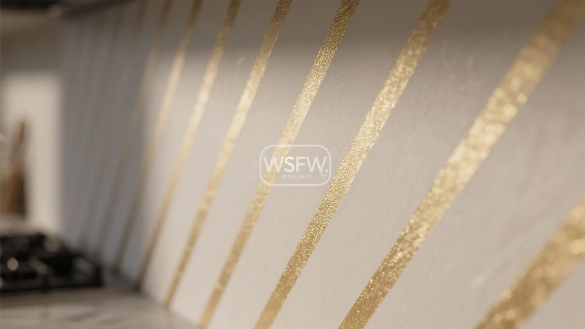 Close up of grey wall panel with diagonal shiny gold stripes and soft warm light effect