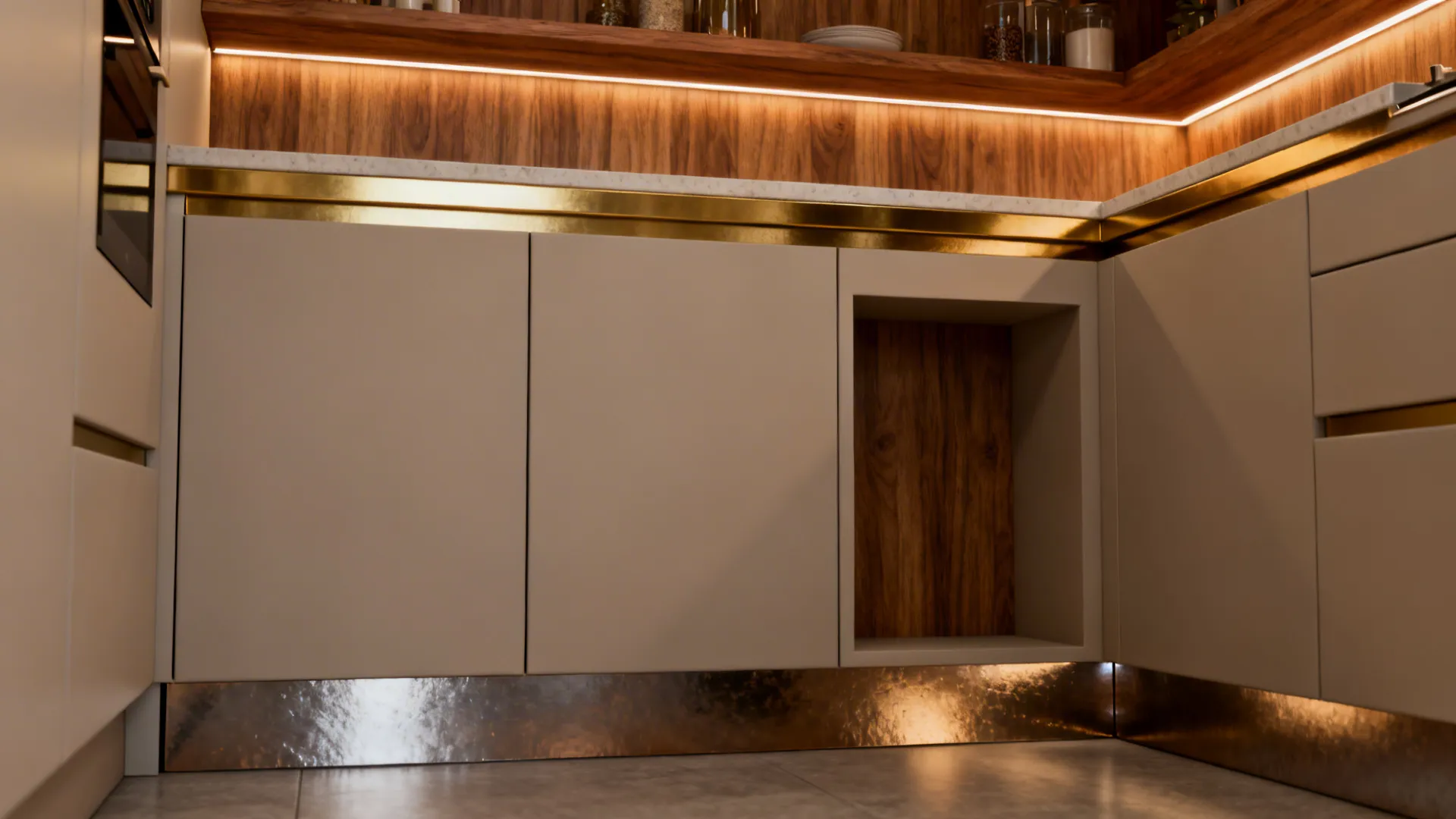 Compact kitchen with brushed brass laminate accents on a ledge, toe-kick, and niche backing.