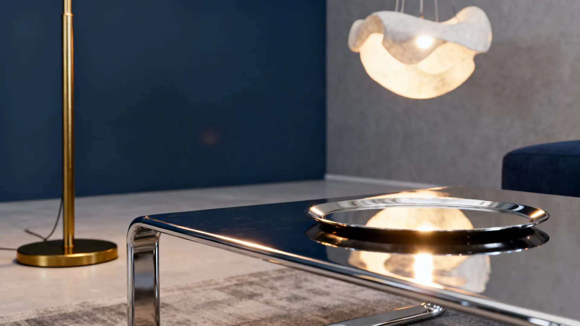 Brass floor lamp and chrome table reflecting light to brighten navy and grey living room tones