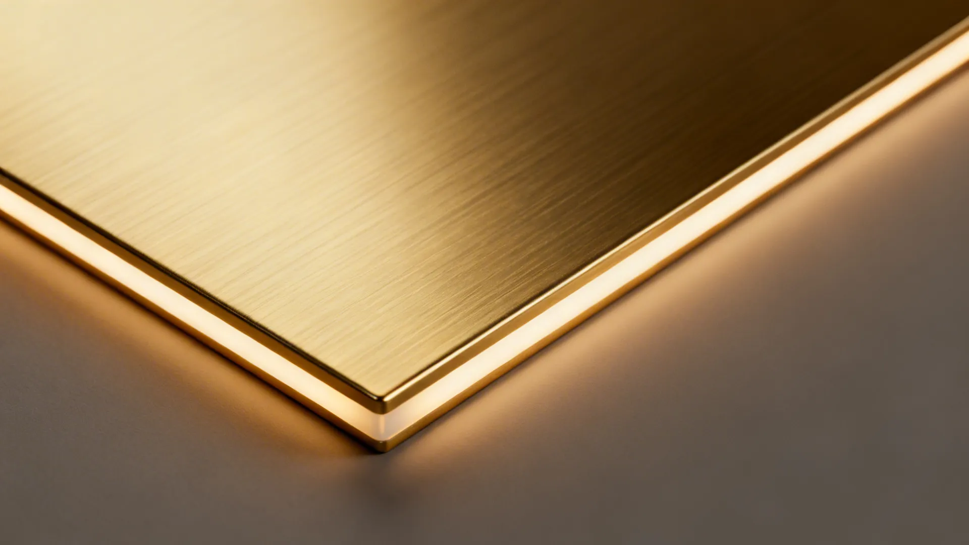 Macro of brushed brass metallic-effect laminate with soft satin sheen and fine linear texture.