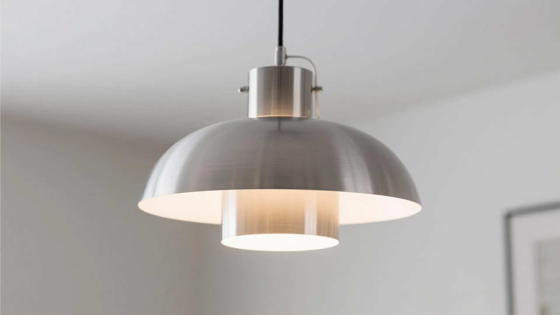 Silver metallic pendant light fixture with warm glow