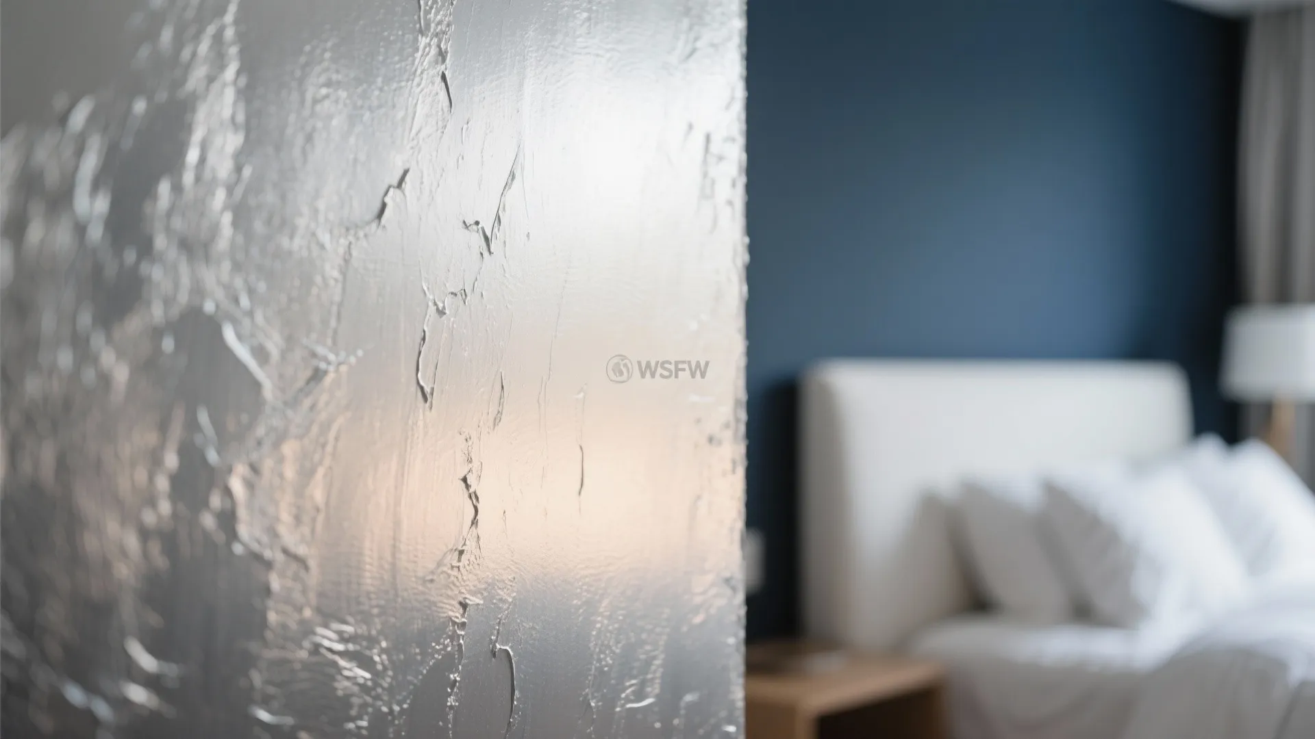 Close-up of a metallic silver-painted bedroom wall catching light