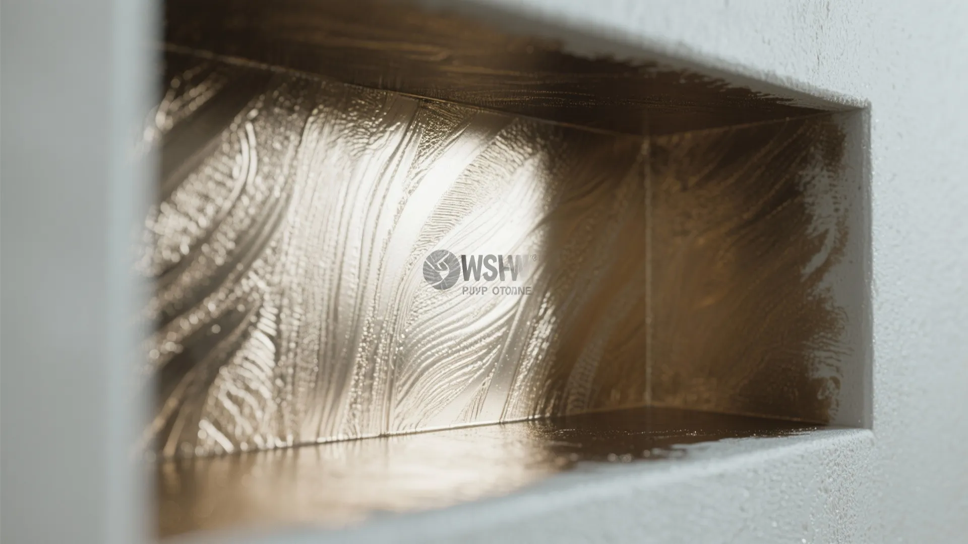 Close up view of gold metallic wall texture inside a small white square wall niche