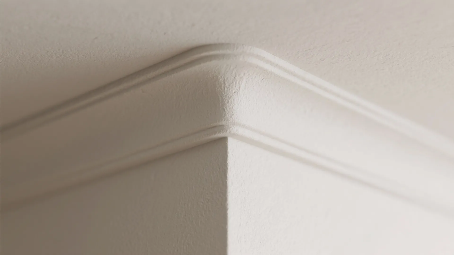 Close-up of a white rounded wall panel corner detail connecting the wall and the ceiling