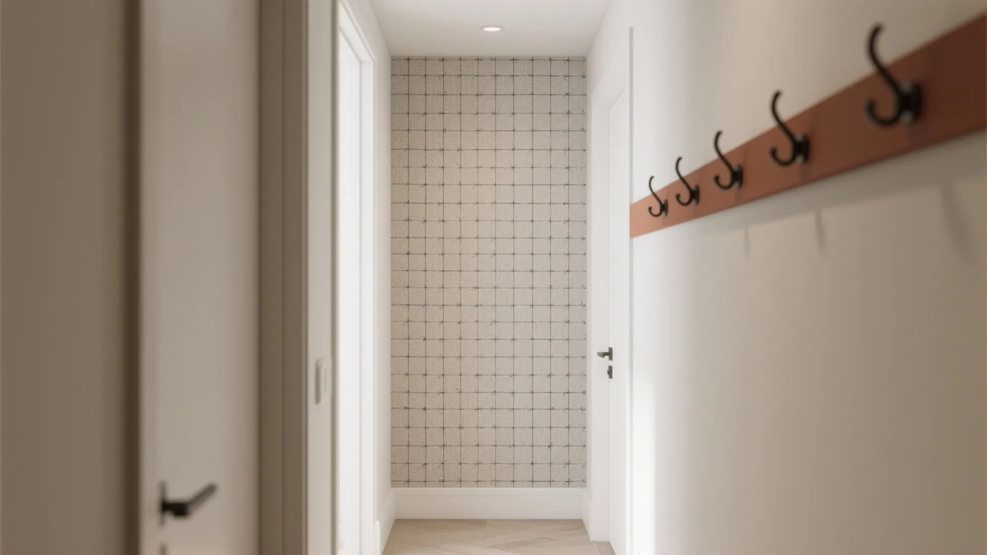 Modern white hallway featuring a grey grid pattern wall and orange coat rack with hooks