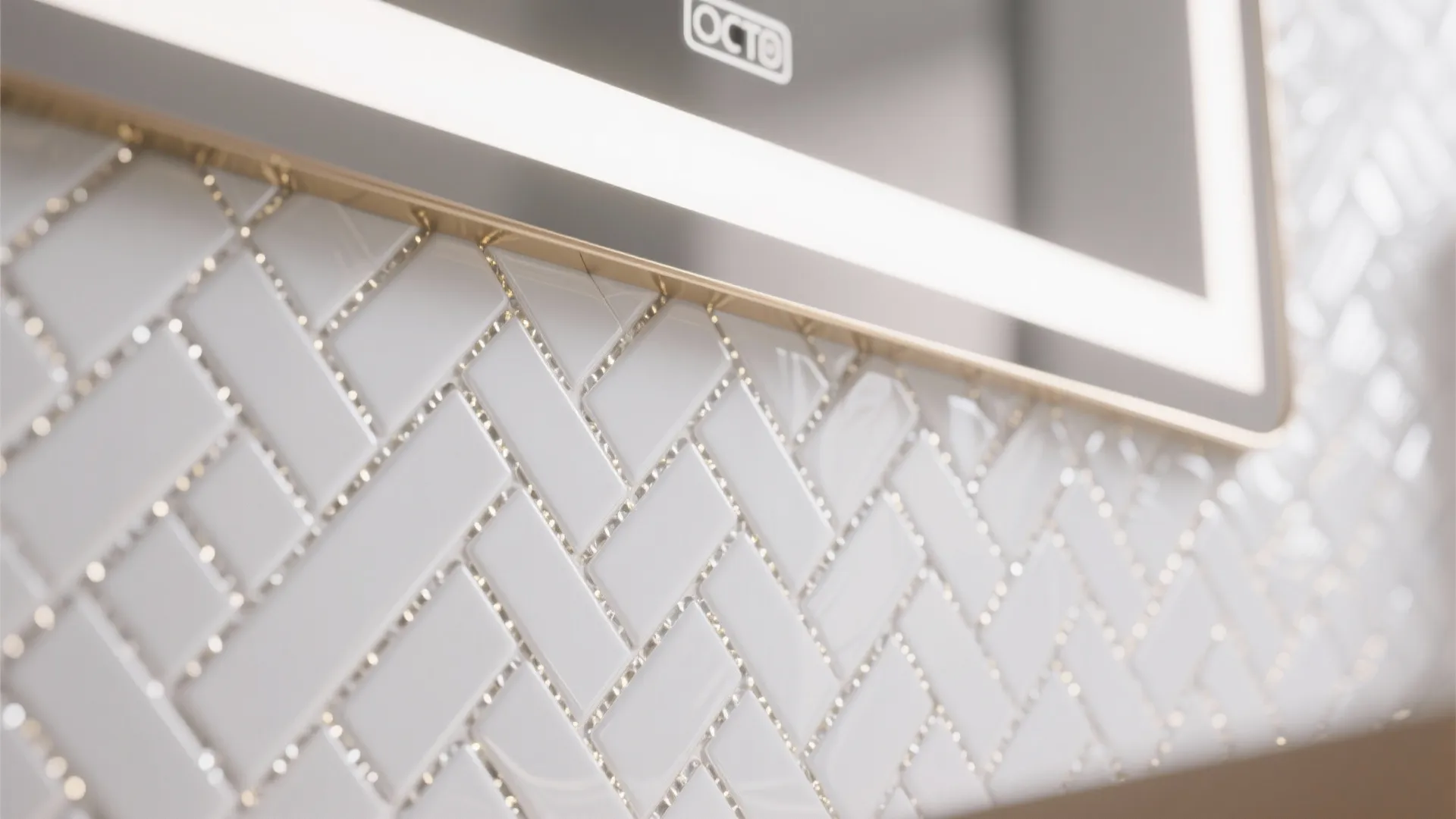 Close up of white small wall tiles in a zig zag pattern near bathroom mirror