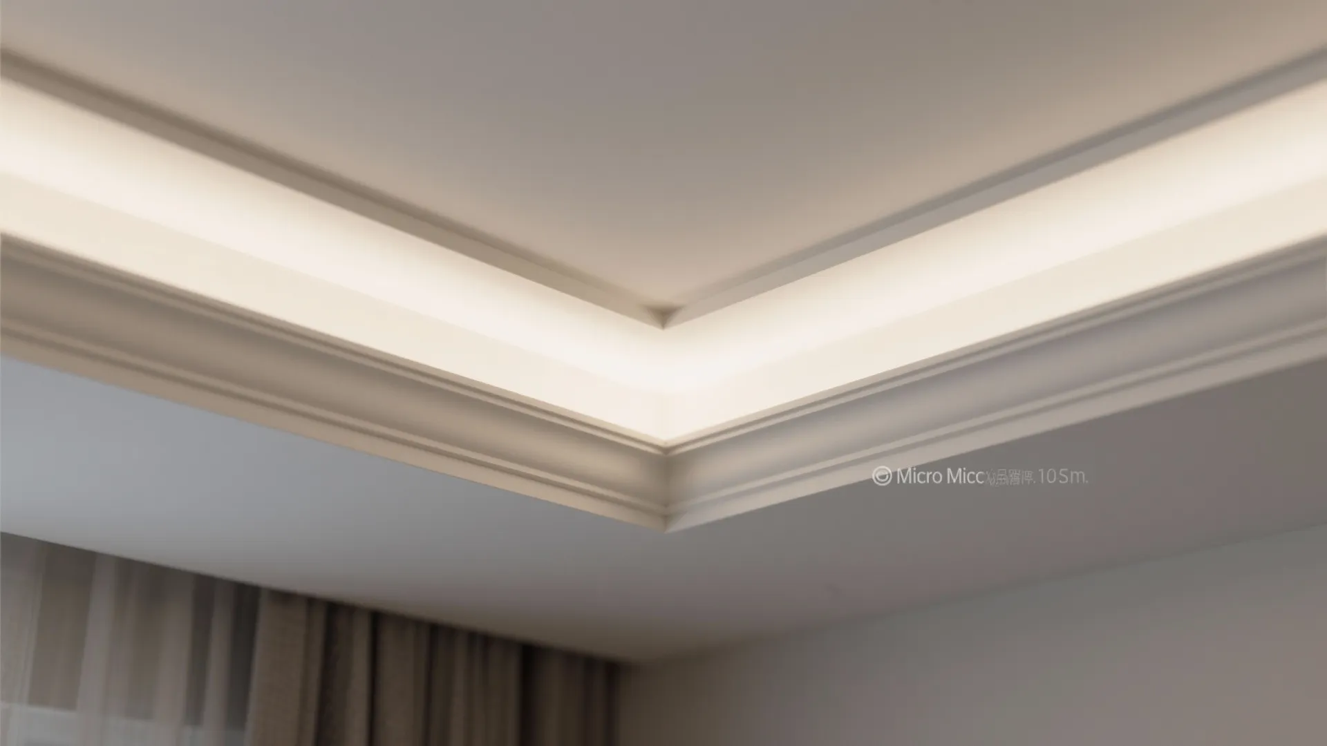 Close up of a modern ceiling corner with built in light fixture and white wall panel