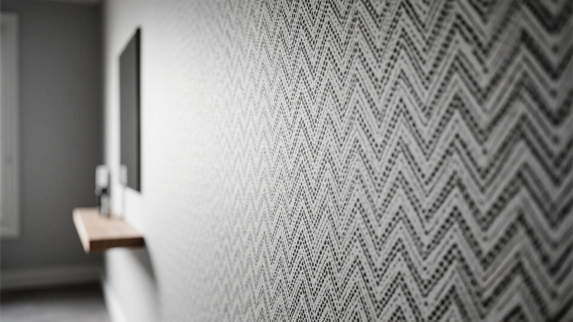 Grey and white zigzag pattern wallpaper on wall with blurred wooden shelf in a room