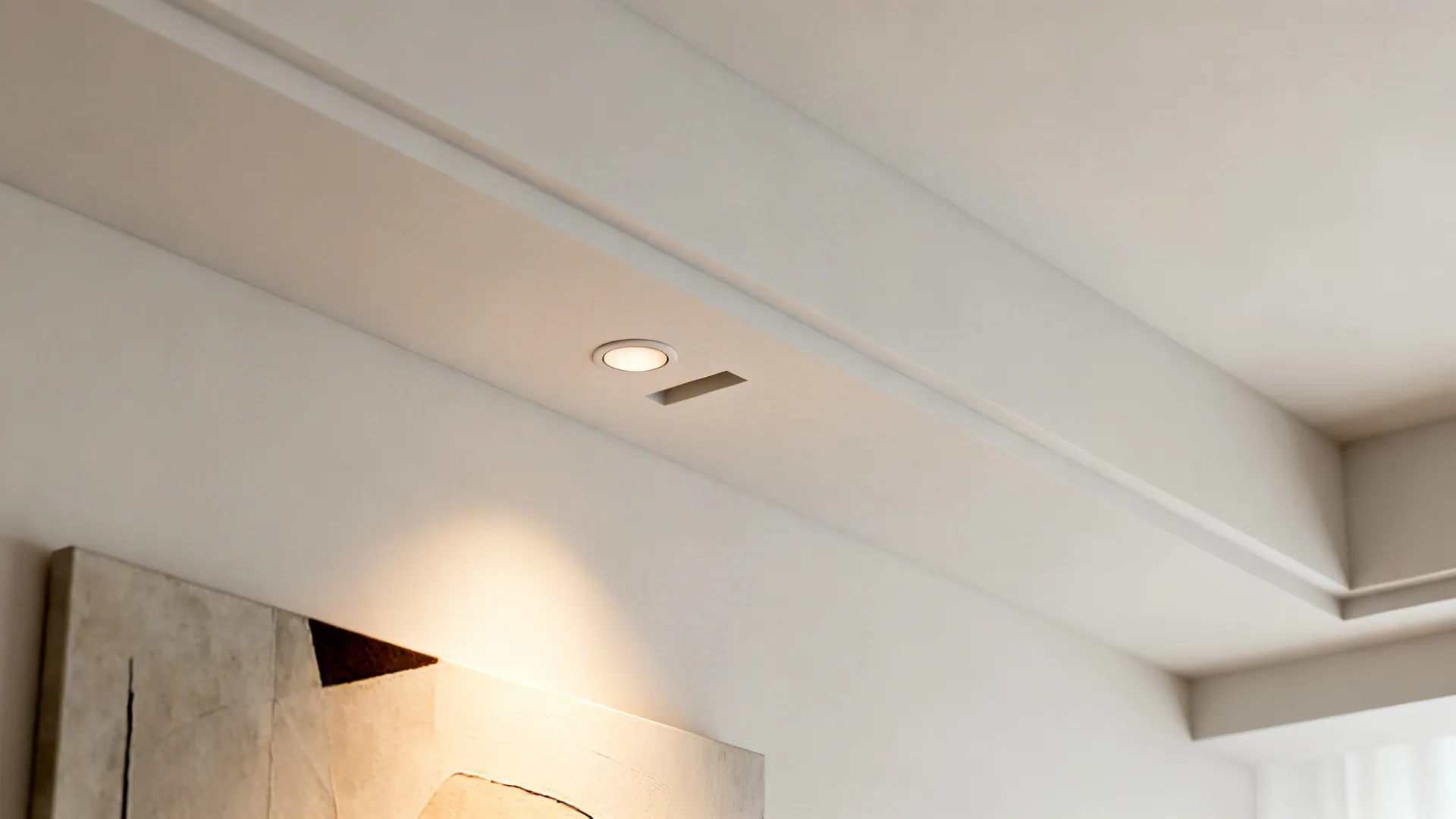 Macro of a trimless micro recessed spotlight set into a clean gypsum beam ceiling.