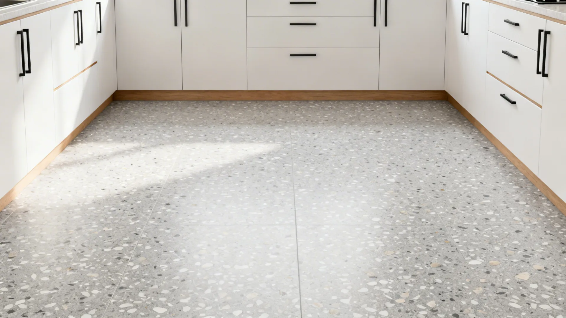 Minimal studio kitchen with light gray micro-chip terrazzo-look porcelain floor.
