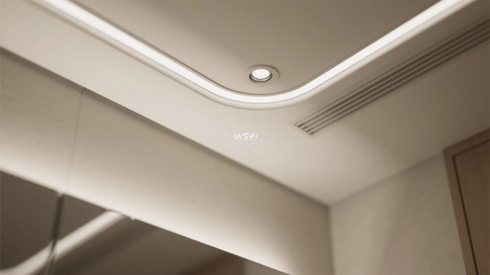 Close up view of a modern white ceiling with curved light strips and small spotlights