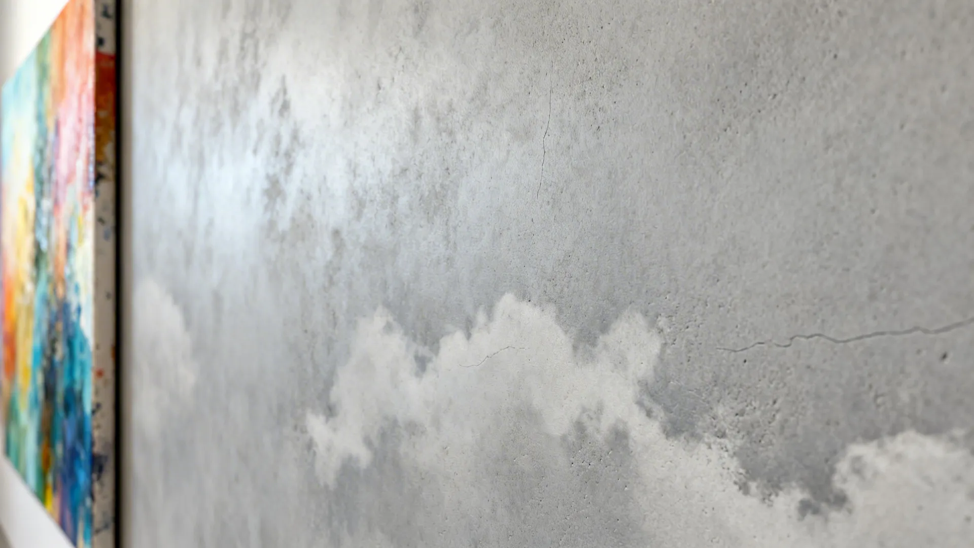 Macro of matte grey microcement showing subtle tonal clouding and smooth texture.