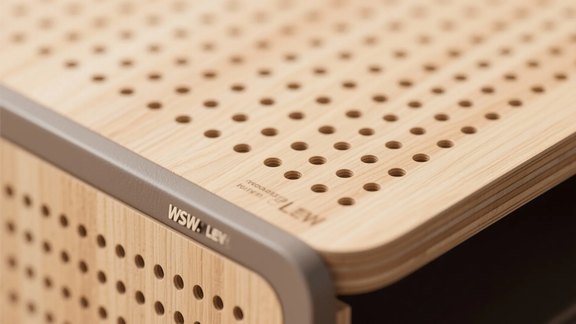 Macro of CNC micro-perforated veneered plywood with clean edge banding and matte finish.