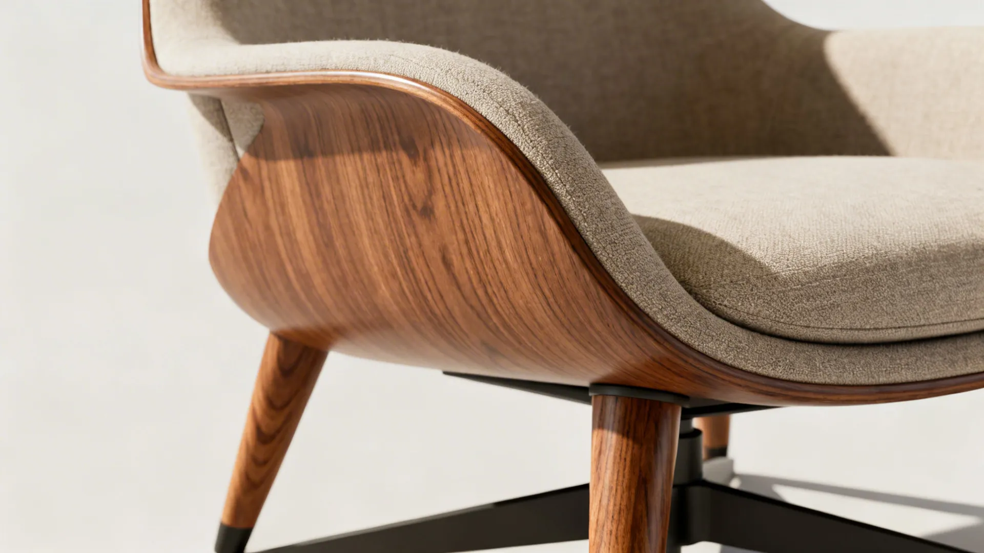 Close-up of a mid-century swivel chair showing wooden legs and neutral upholstery texture.