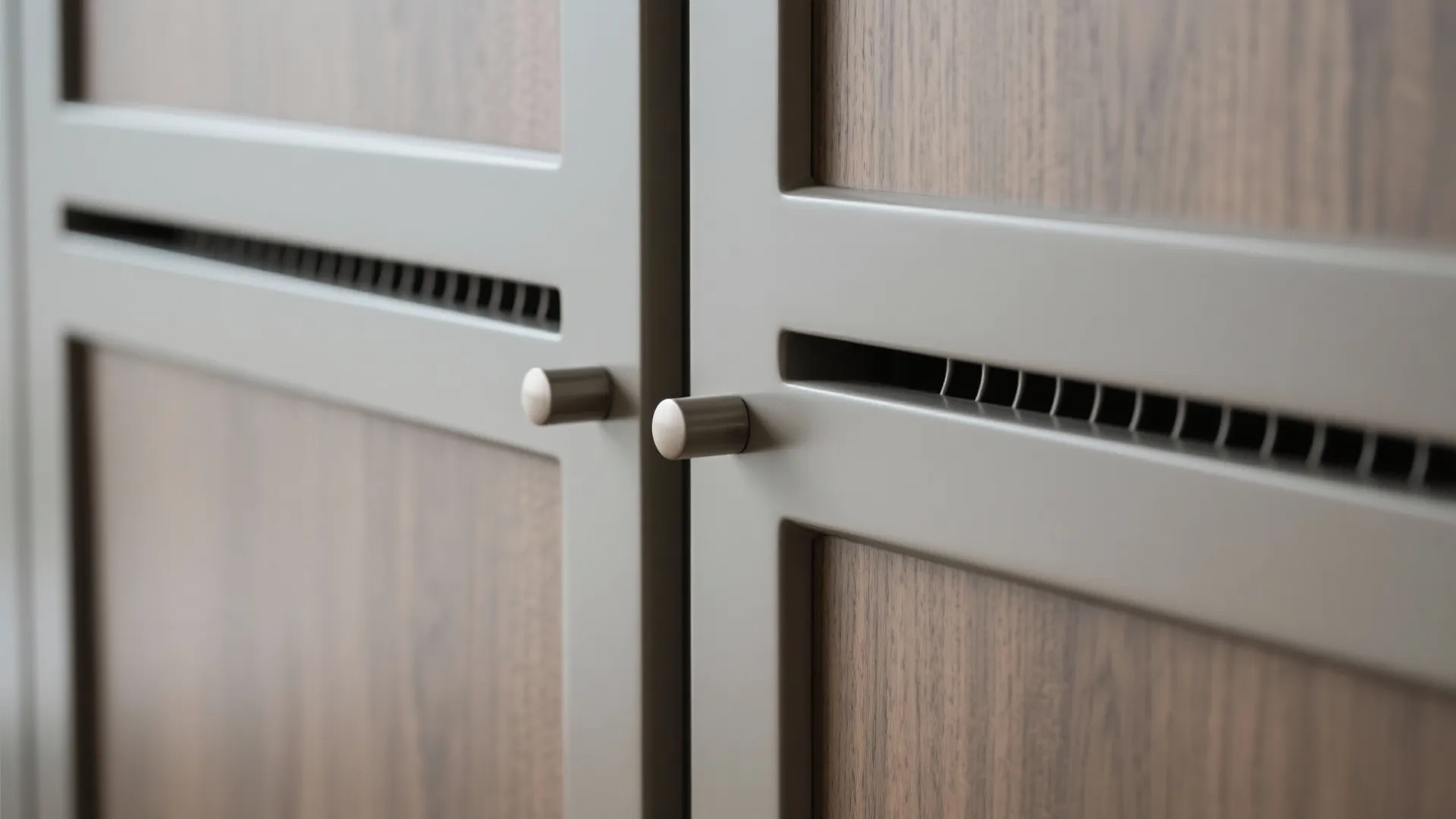 Close-up of concealed-pull matte panel with soft-close hardware and ventilation gap.