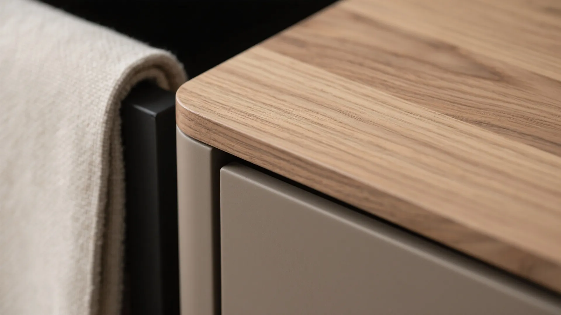 Close up of wood table top with rounded edges and beige cabinet in modern room design