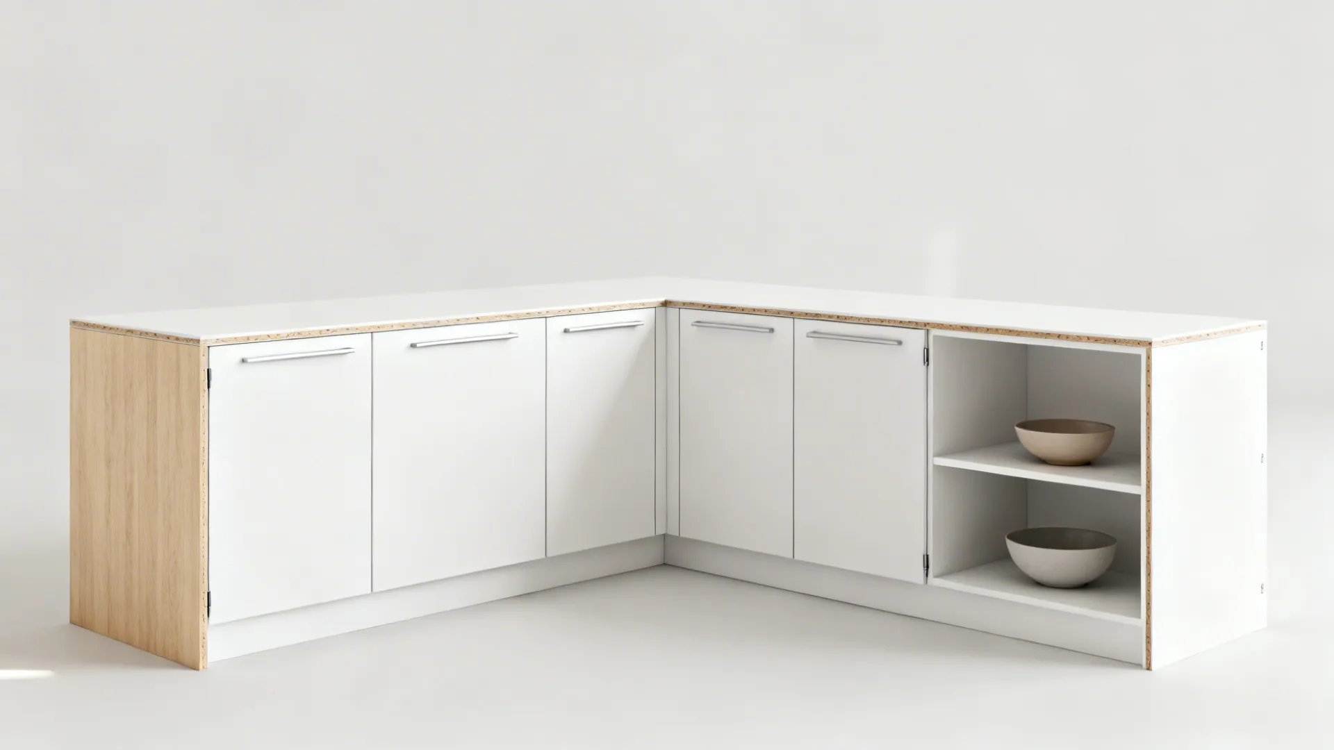 Minimalist flat-pack cabinetry with white slab doors and plywood edges in a compact L-shaped kitchen.