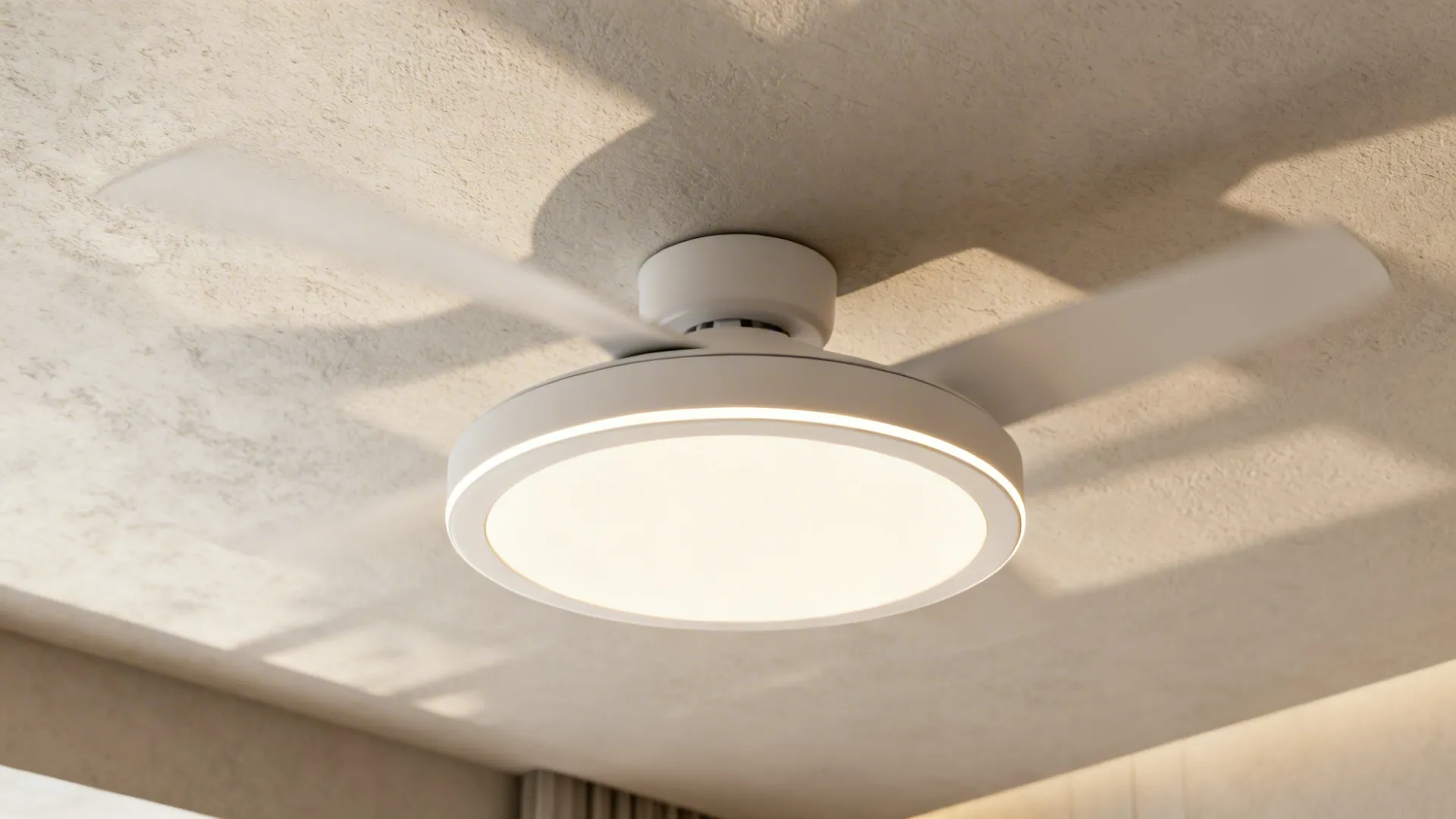 Close-up of a slim integrated-LED ceiling fan with warm diffusion in a contemporary living room.