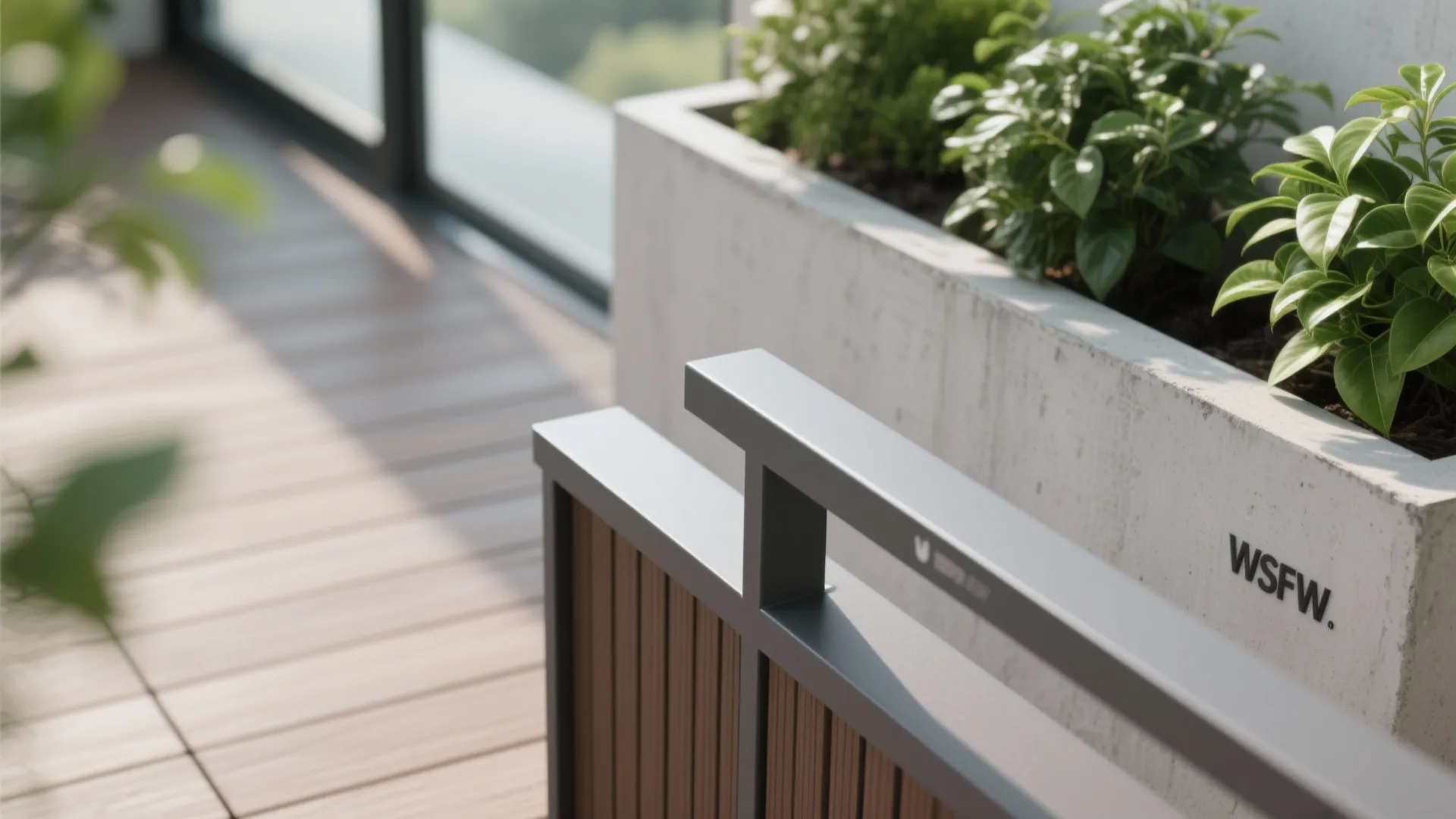 Close up of outdoor balcony featuring concrete planter box with green plants and wooden floor tiles