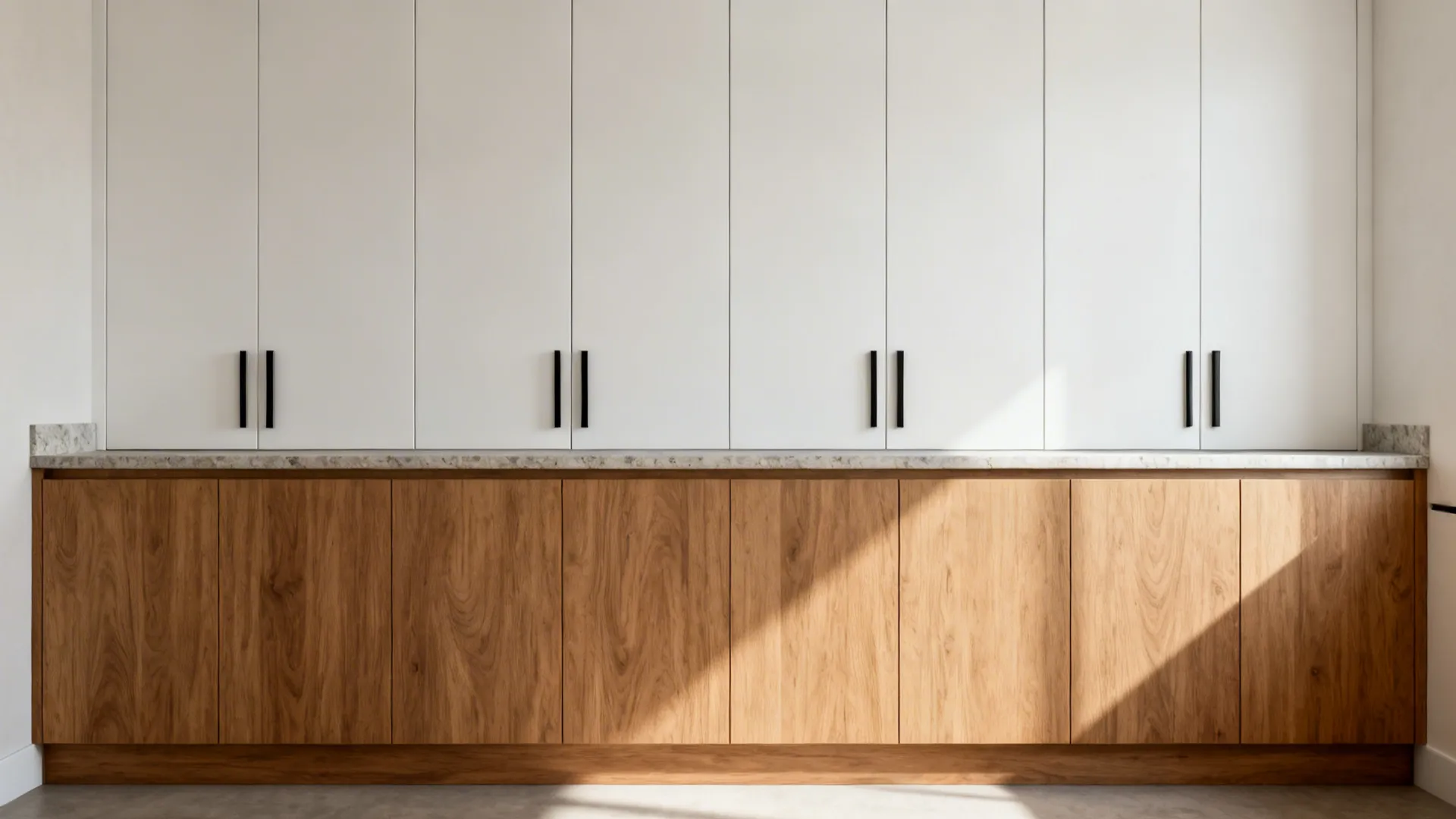 Minimalist kitchen storage with aligned cabinet reveals and warm wood fronts.