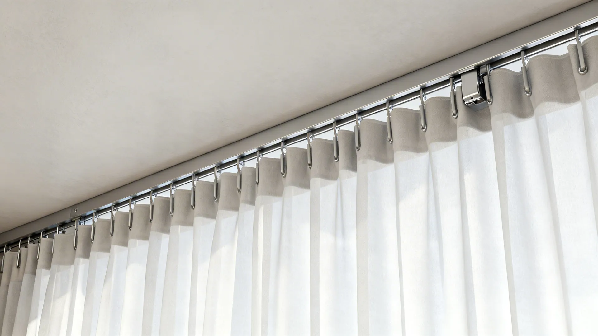 Close-up of a ceiling-mounted minimal curtain track and pocketed curtain highlighting clean architectural finish.