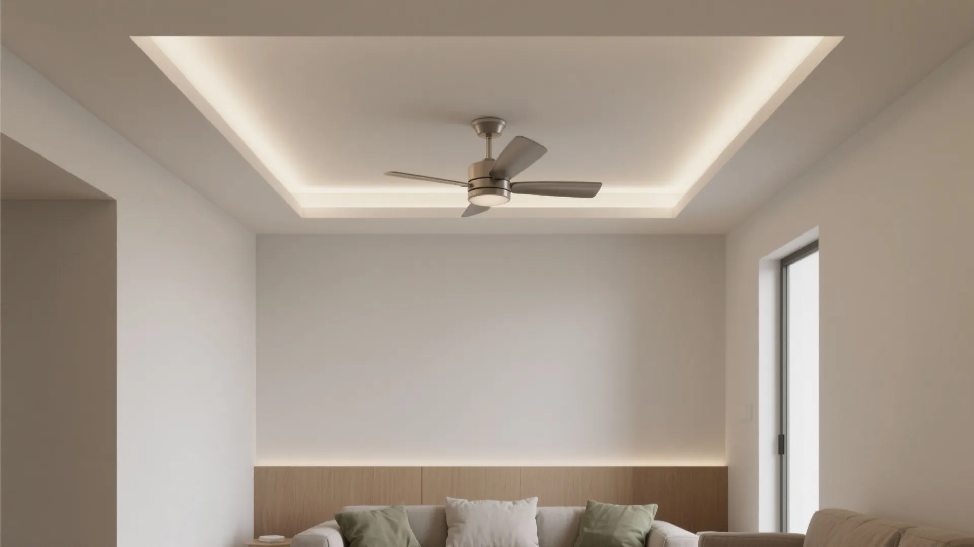 Modern living room featuring a ceiling fan with light under a white tray ceiling design