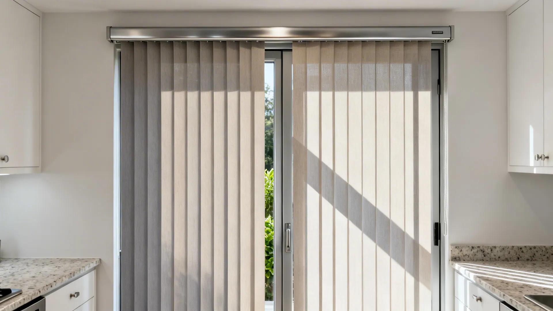 Sliding kitchen door with slim light-filtering vertical blinds softly shading a bright modern space.