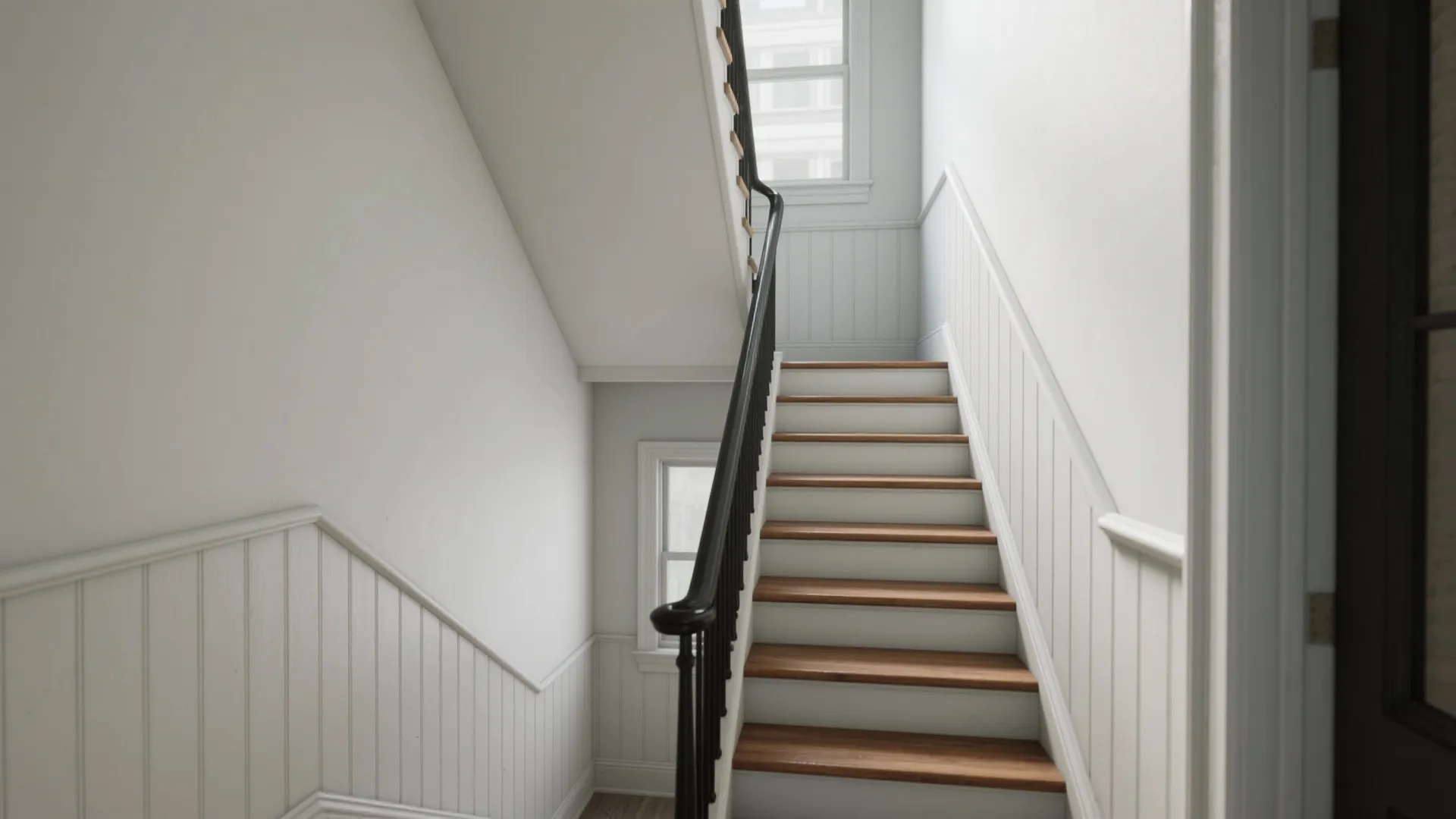 Minimalist Wainscoting That Stretches the Stairwell