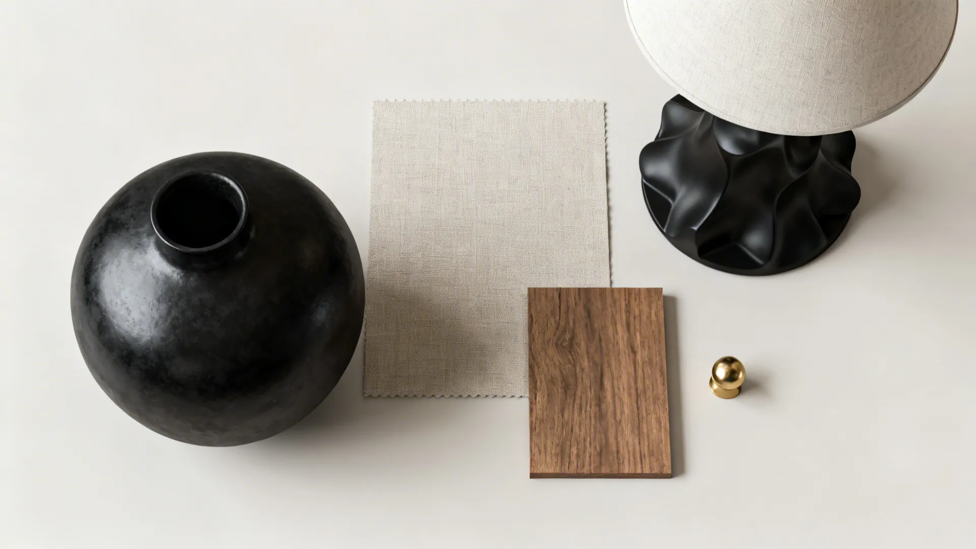Flatlay of curated minimalist accessories for a black-themed living room
