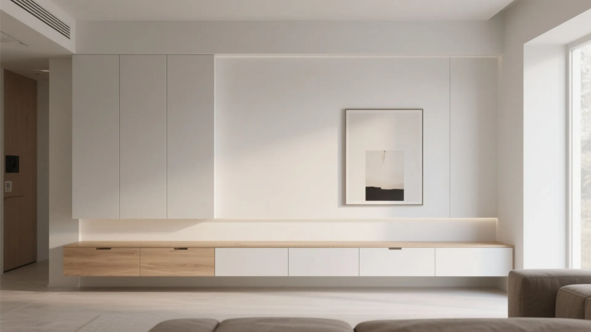 Minimalist white wall cabinet with wooden shelf featuring a framed picture and soft natural sunlight