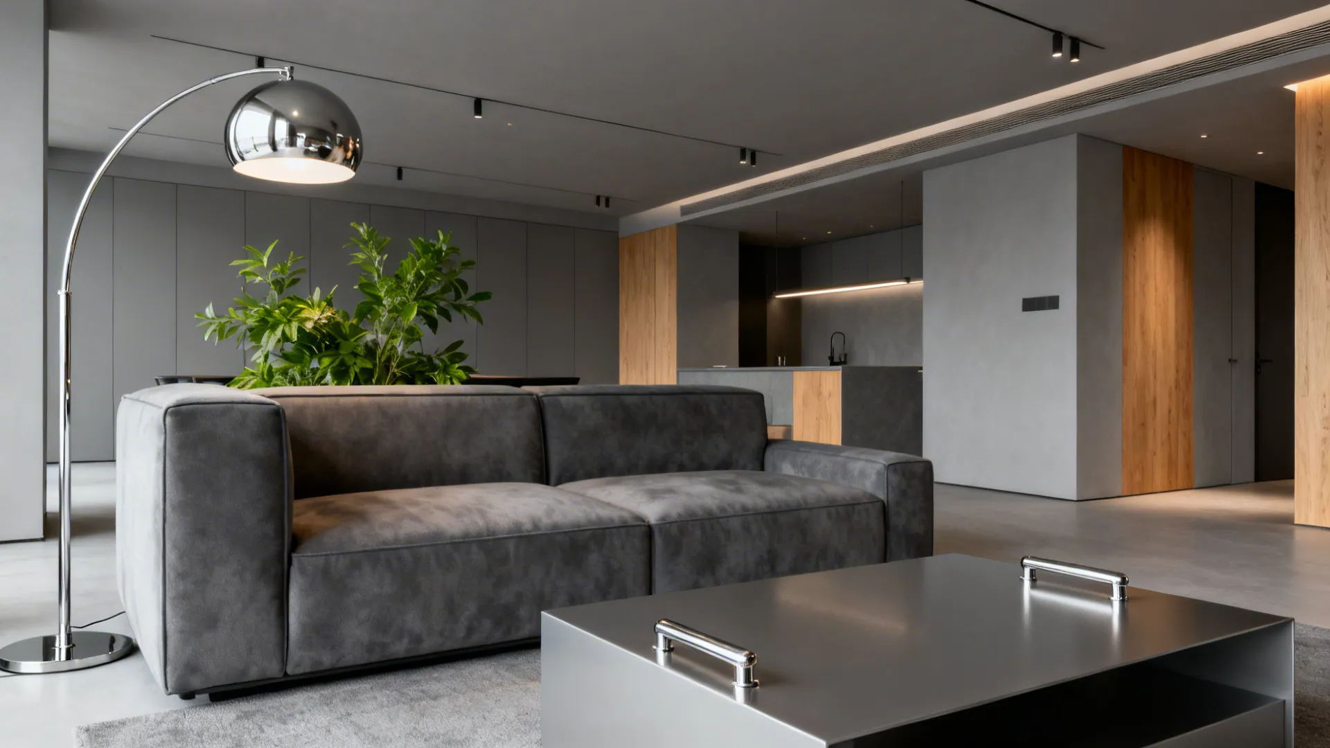 Minimalist grey living area with polished silver lamp and wood accents for warmth.