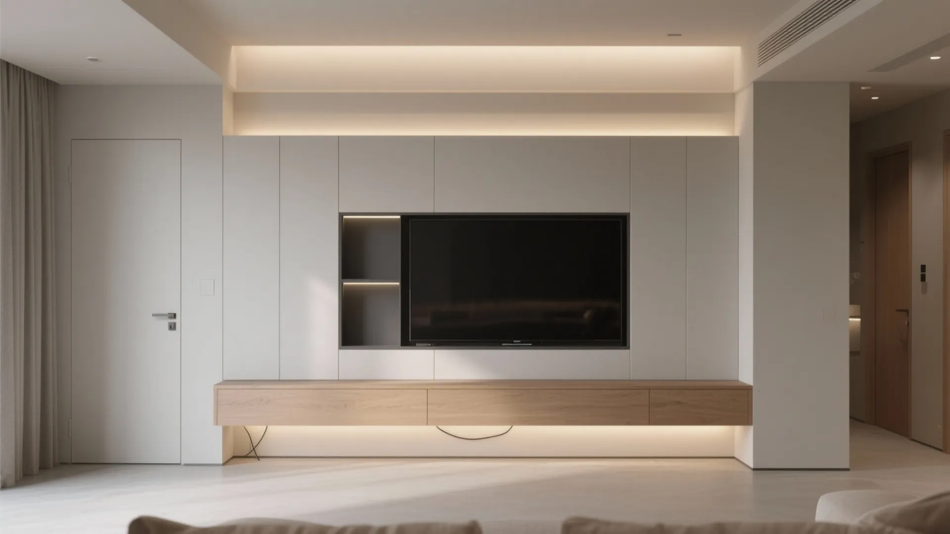 Minimalist white living room with television integrated into wall paneling and a floating wooden cabinet
