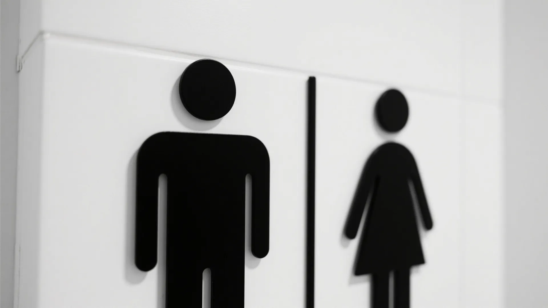 Minimalist line art icons indicating male and female bathrooms