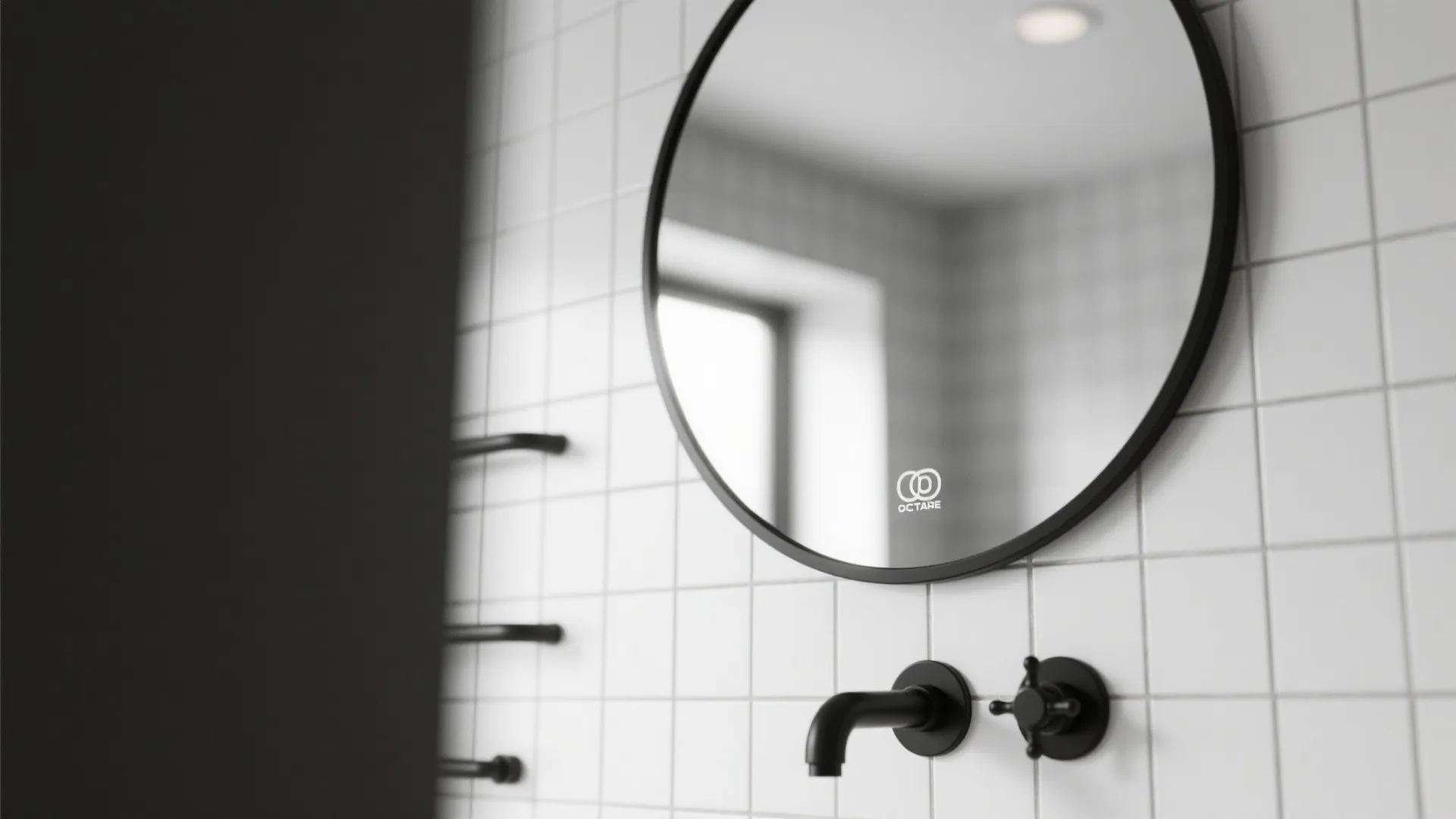 Minimalist round bathroom mirror with black frame mounted on white square tile wall with faucet