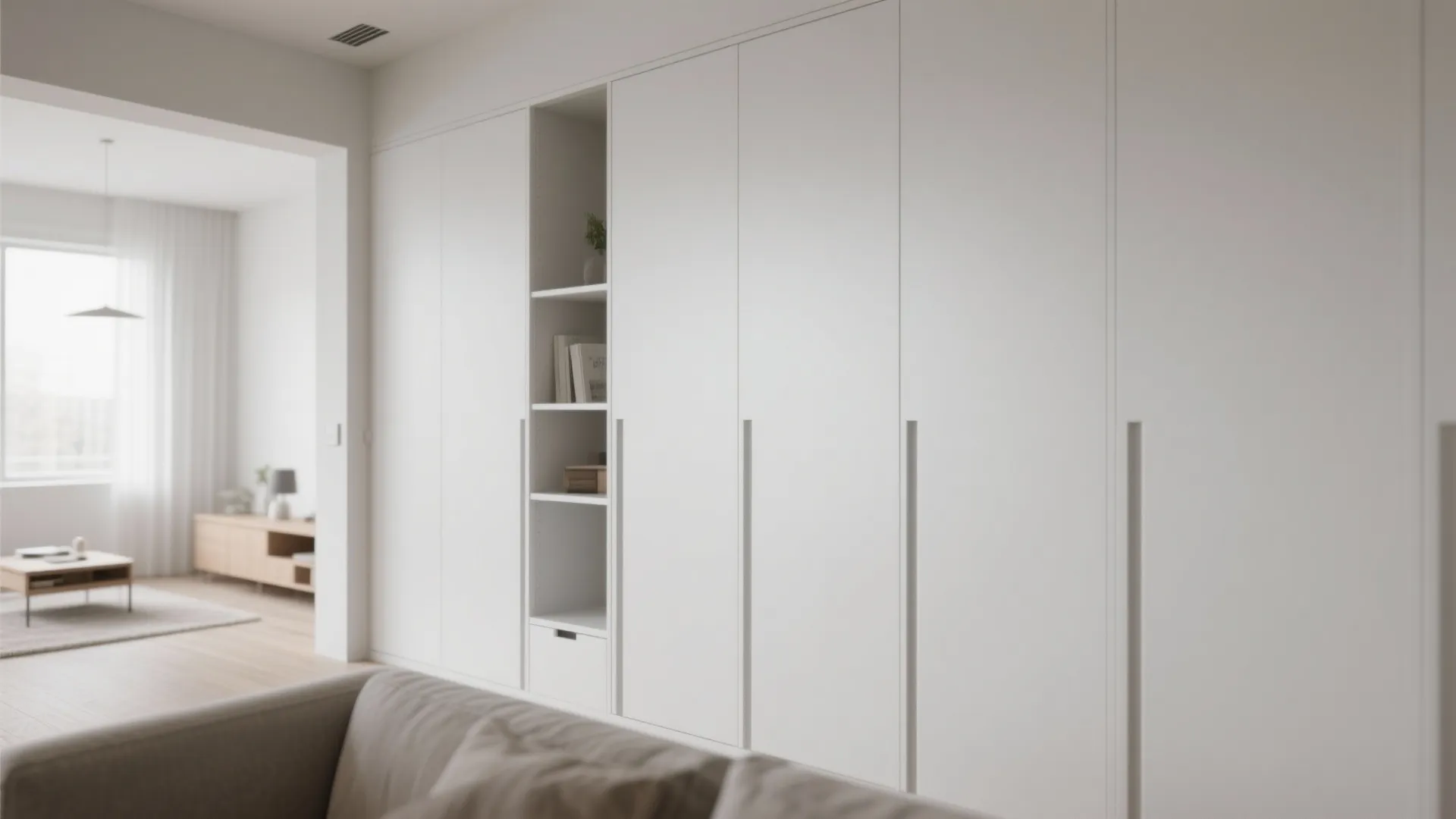 Minimalist hidden wall cabinetry in small open plan space