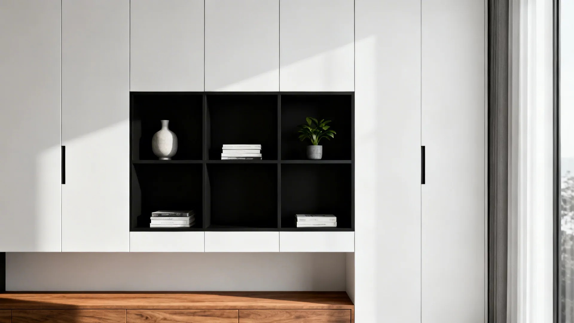 Integrated white cabinetry with black open shelving and curated decorative objects.