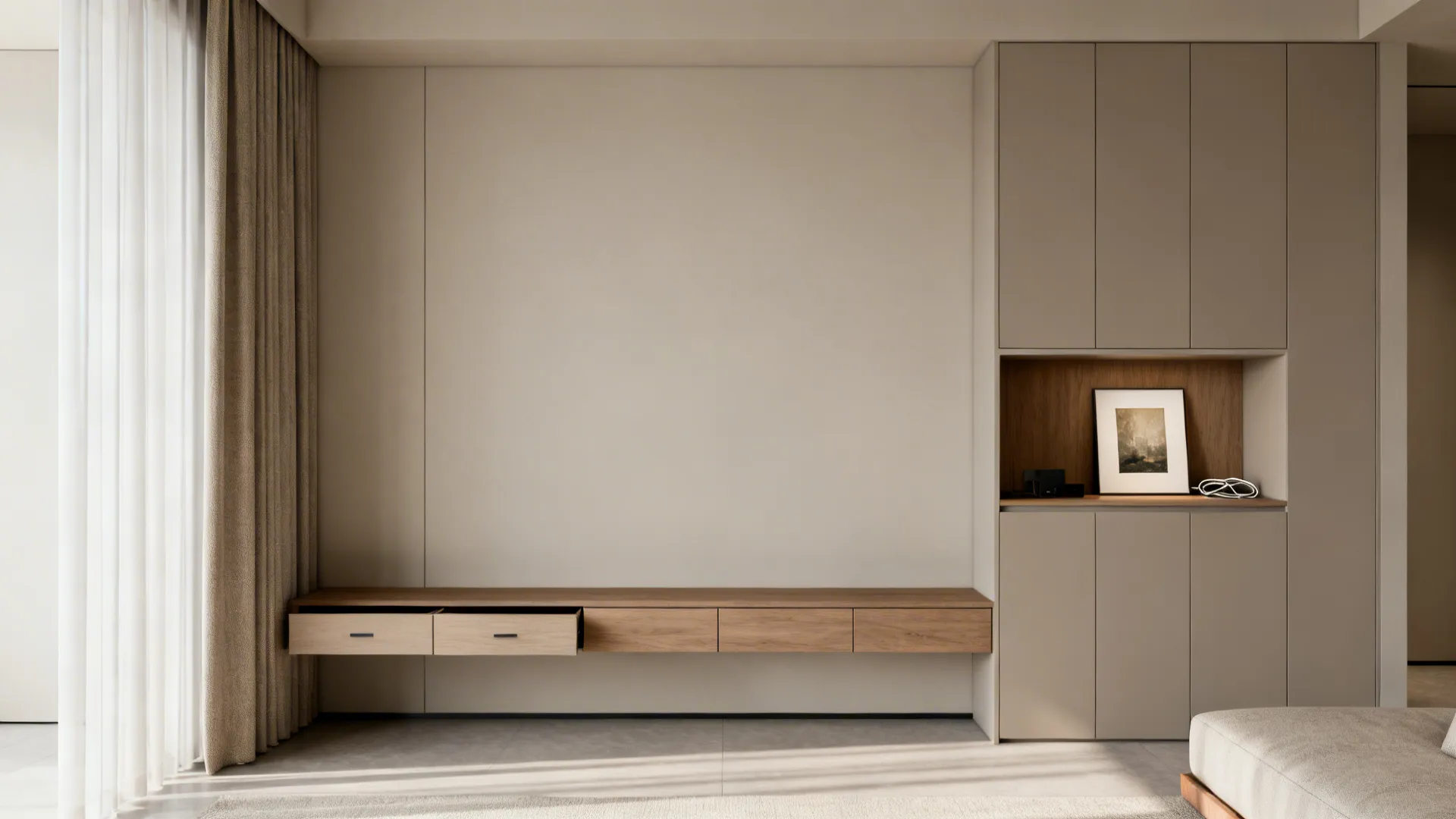 Handleless wall cabinets and a slim console in matching greige create a calm, clutter-free drawing room.
