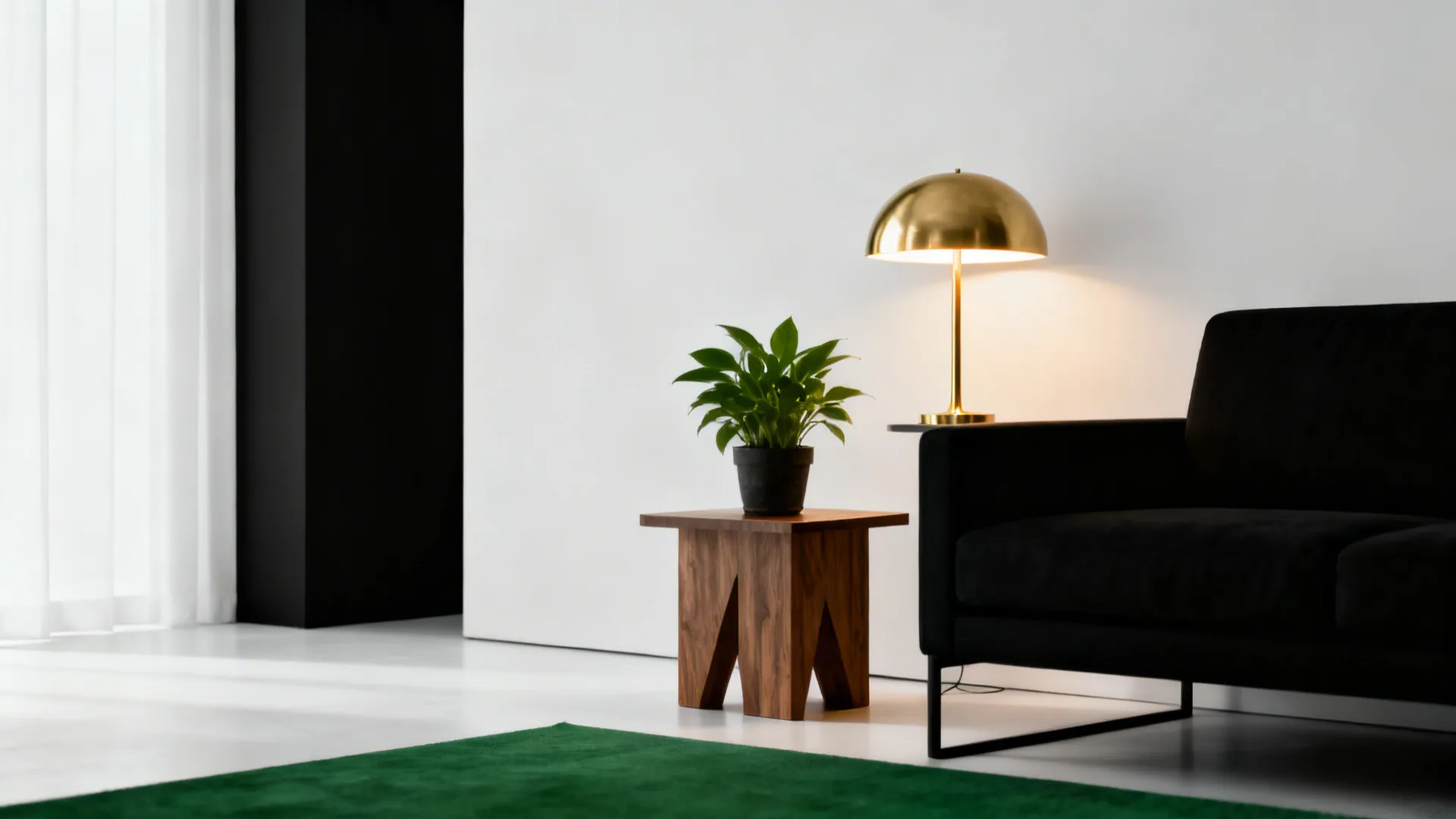 Minimalist black-and-white living room with a warm brass lamp, wooden side table and plant.