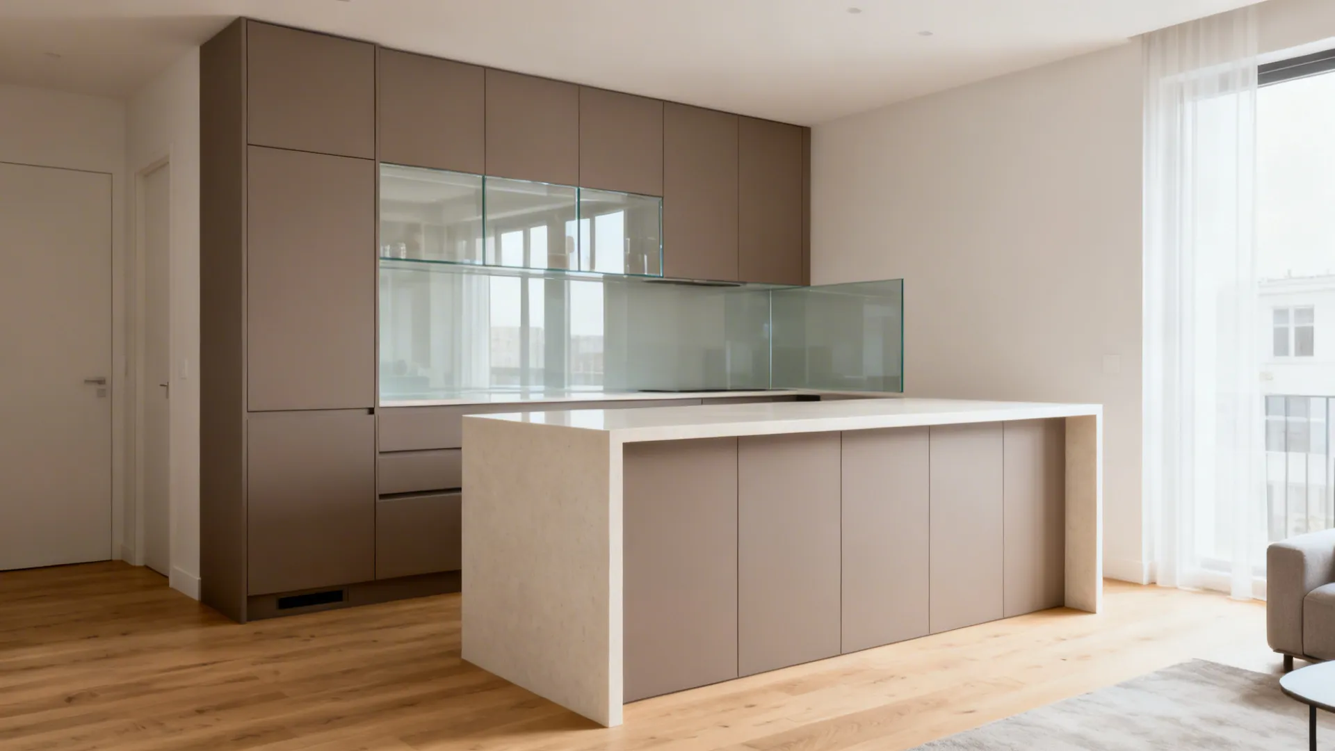 Slim waterfall-edge quartz island visually divides a small kitchen and living area.