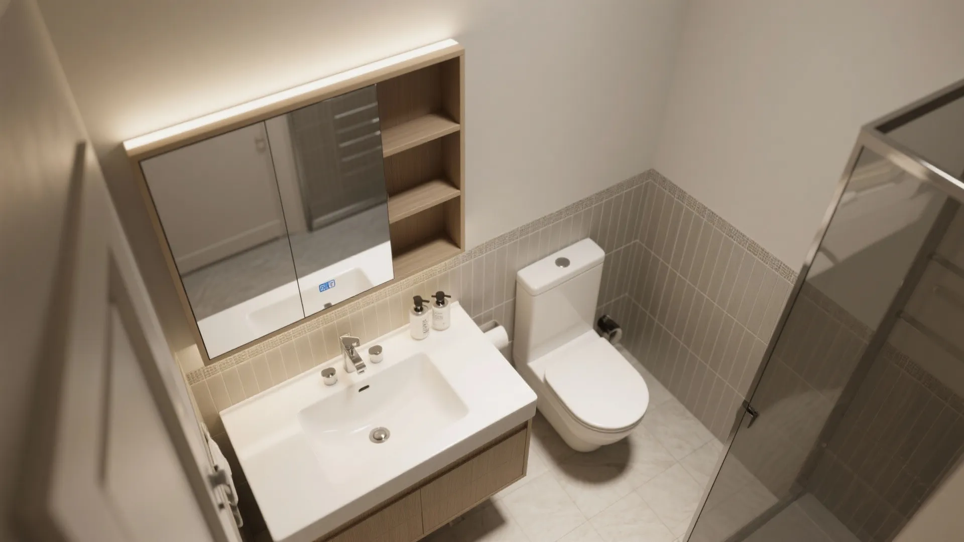 Modern bathroom with white sink wooden cabinet mirror light fixture toilet and grey tiled walls
