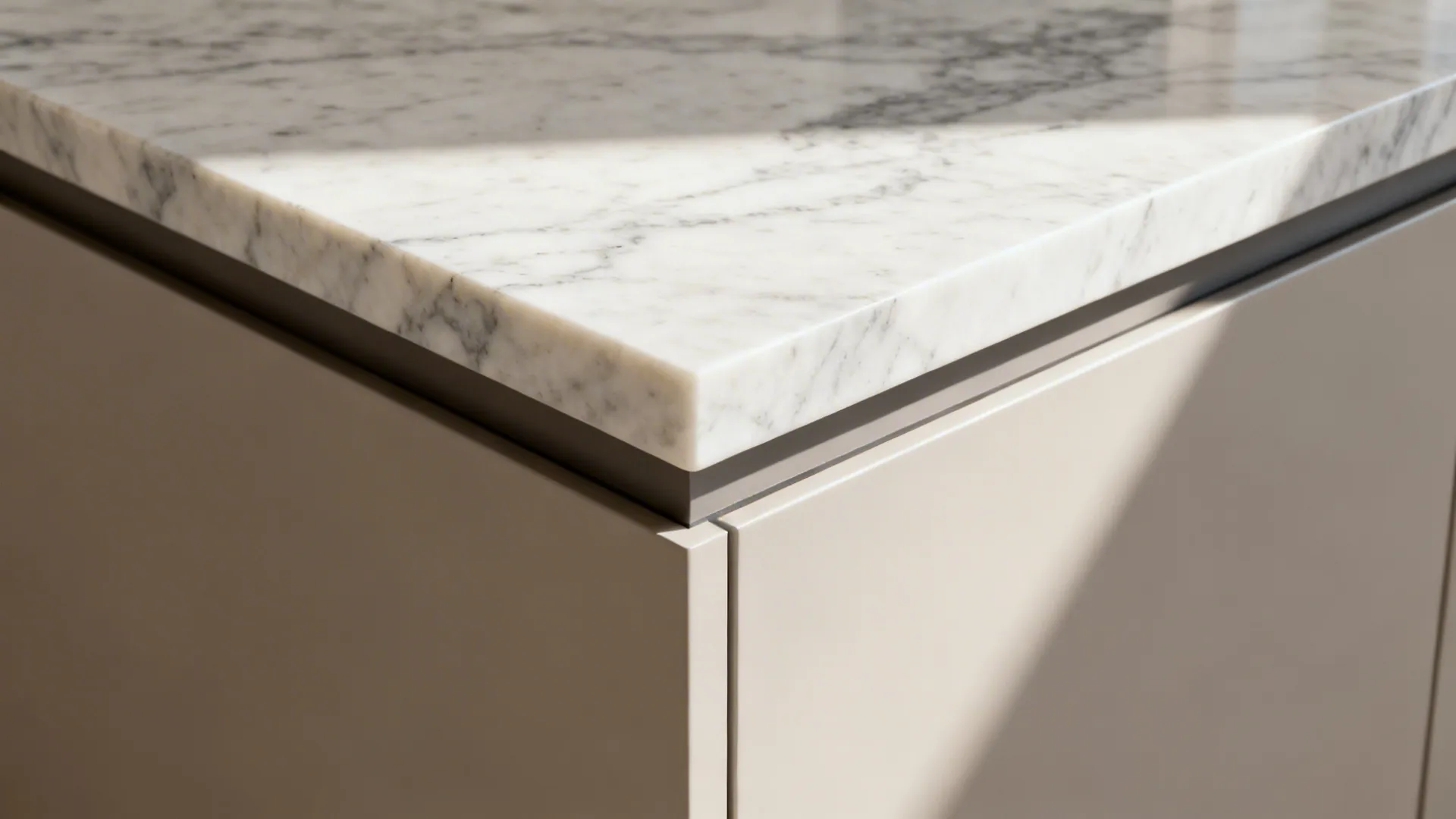 Macro of quartz mitered waterfall edge with a small chamfer and subtle shadow line.