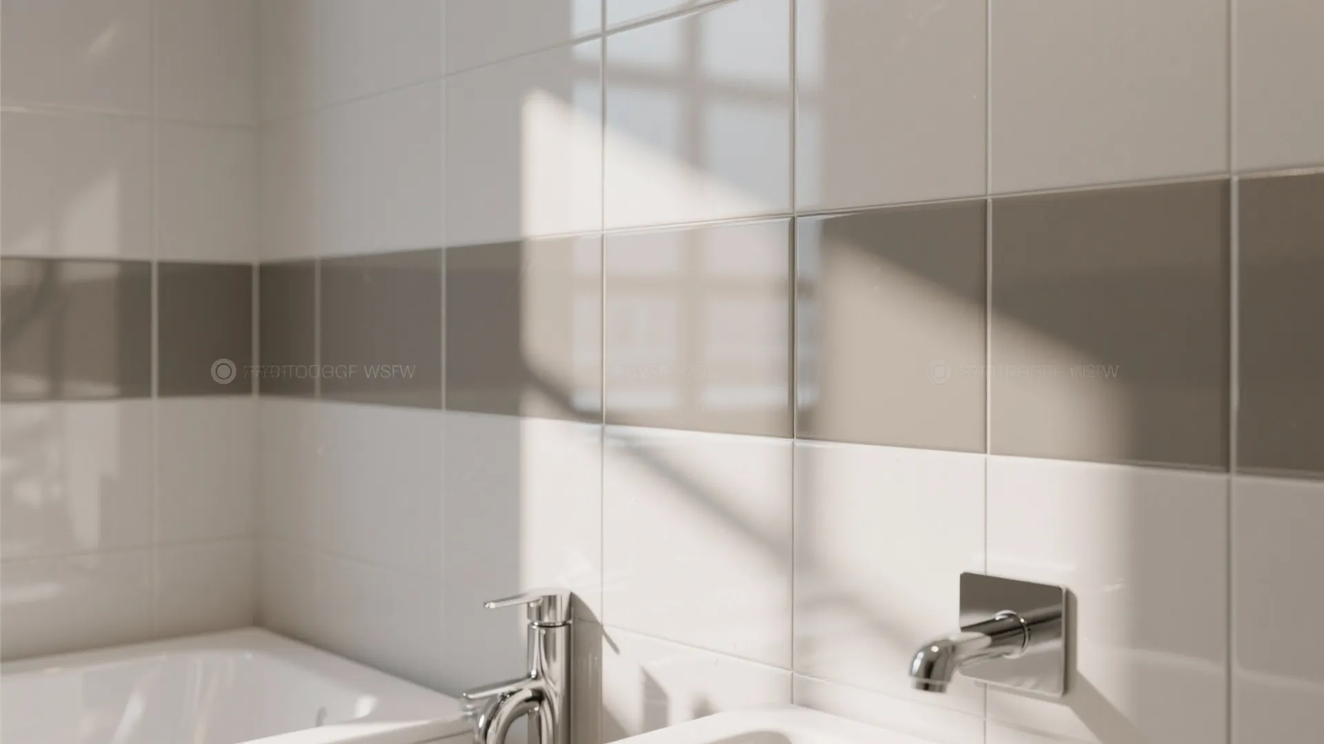 Modern bathroom wall with white and grey square tiles featuring chrome water taps and natural sunlight