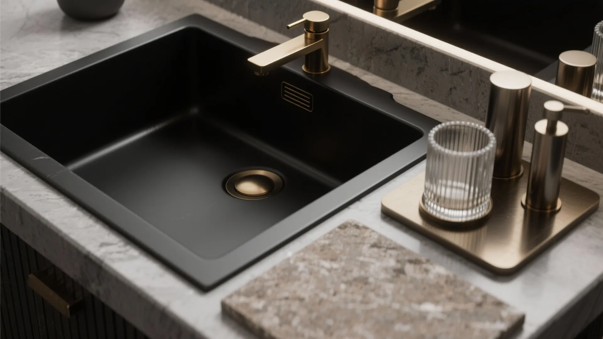 Modern black kitchen sink with gold water tap and soap dispensers on white marble countertop