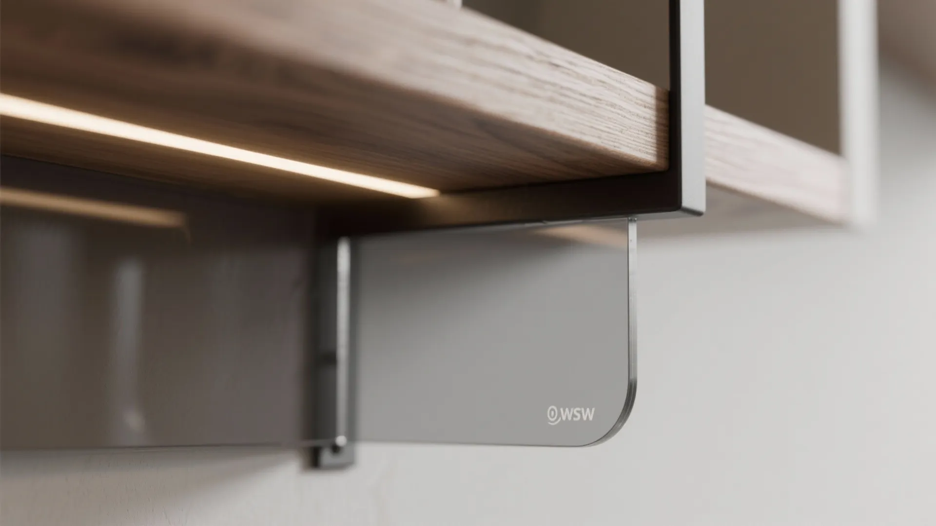Macro of oak grain meeting smoked glass and a slim matte black steel bracket with warm LED glow.