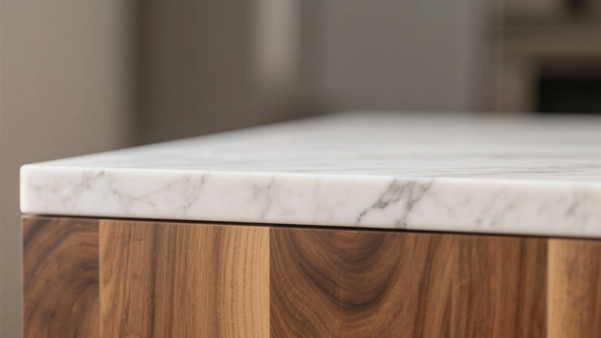 Close up of white marble kitchen counter surface sitting on top of dark wooden storage cabinet