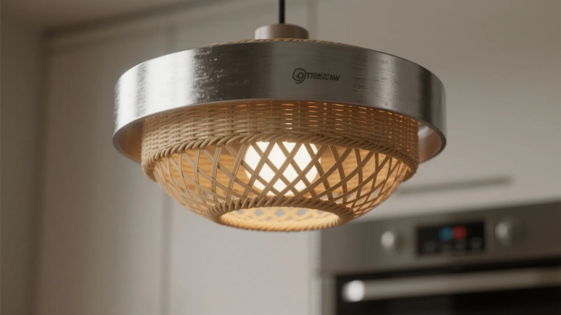 Close up view of modern ceiling light with metal rim and woven shade in kitchen
