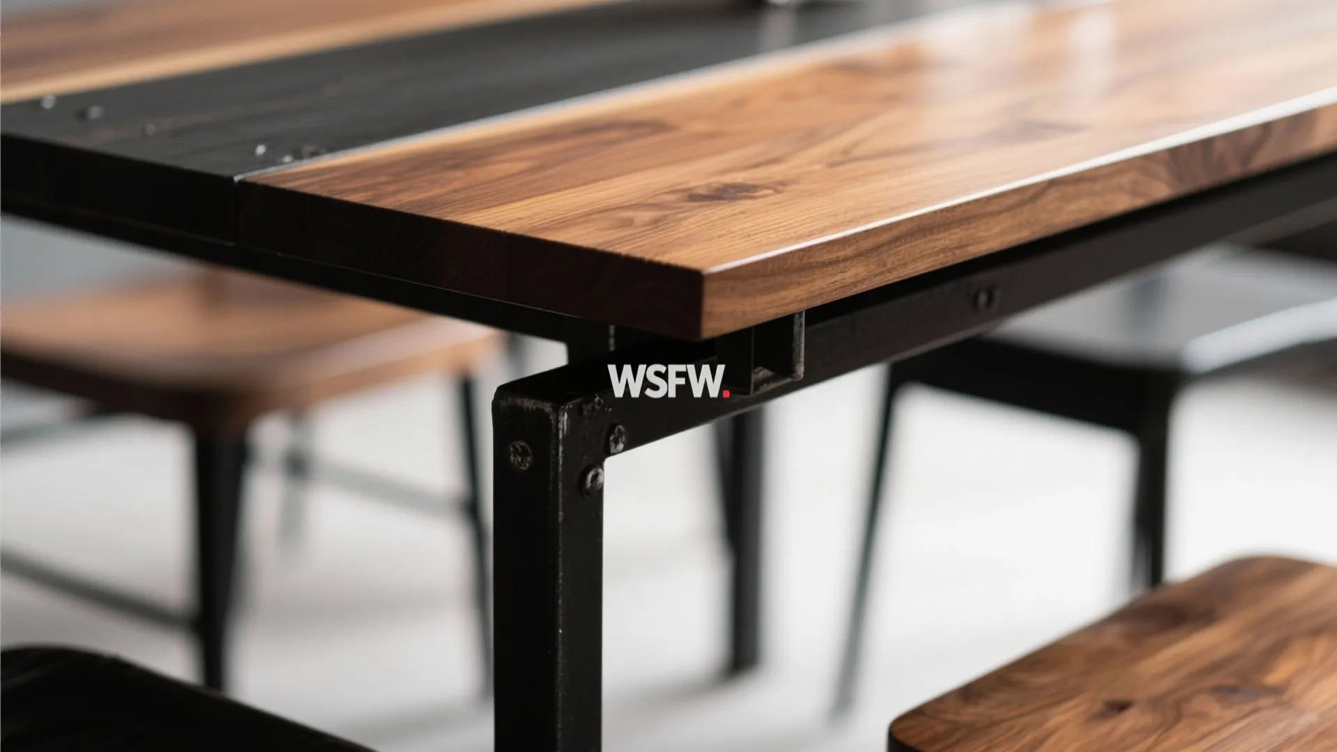 Solid wood dining table with black metal base and matching wooden chairs in bright room